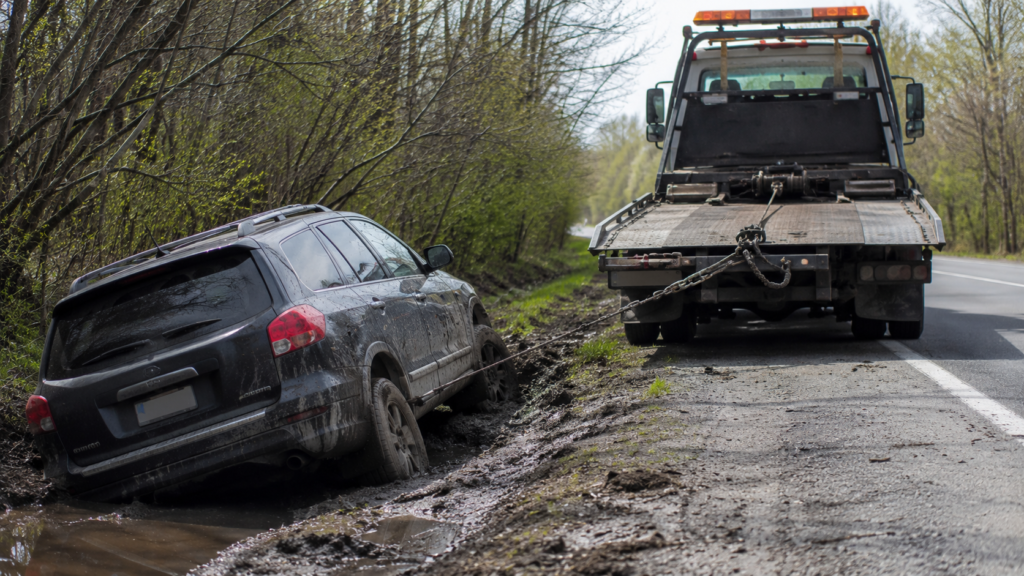 Tow truck winching a vehicle out of mud in East Orange NJ